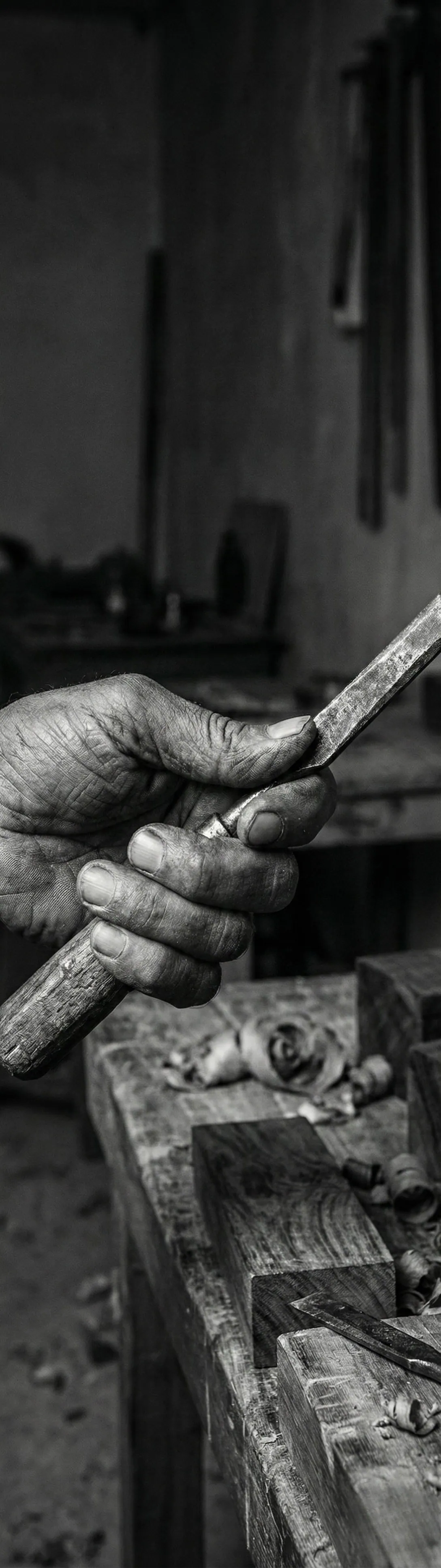 Master artisans hand-carving Sheesham wood furniture in Pakistan